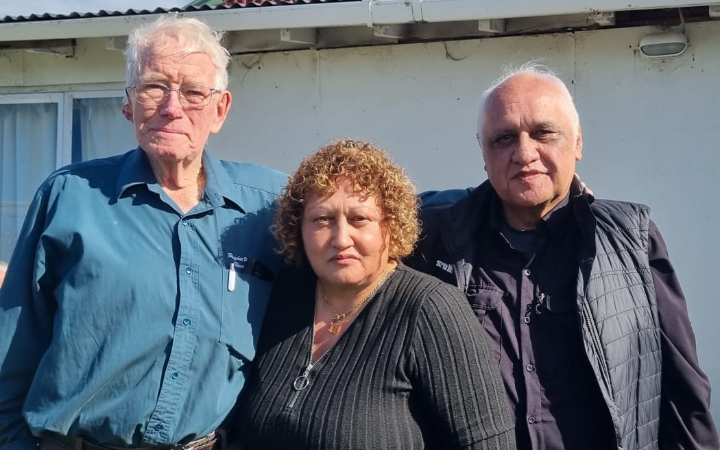 Retiring businessman Hughie Hughes (left) with new owners Josie Wilkie Reedy and her husband Eruera Reedy at a function last week to mark the passing of the baton for Ruatoria's multifaceted store. Photo / Paora Brooking