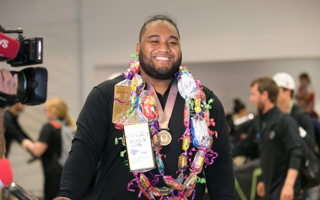 Gold medal weightlifter David Liti was greeted by family and fans in Auckland.