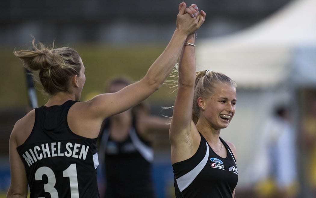 New Zealand hockey player Stacey Michelsen celebrates a goal against Australia in 2014 with Michaela Curtis.