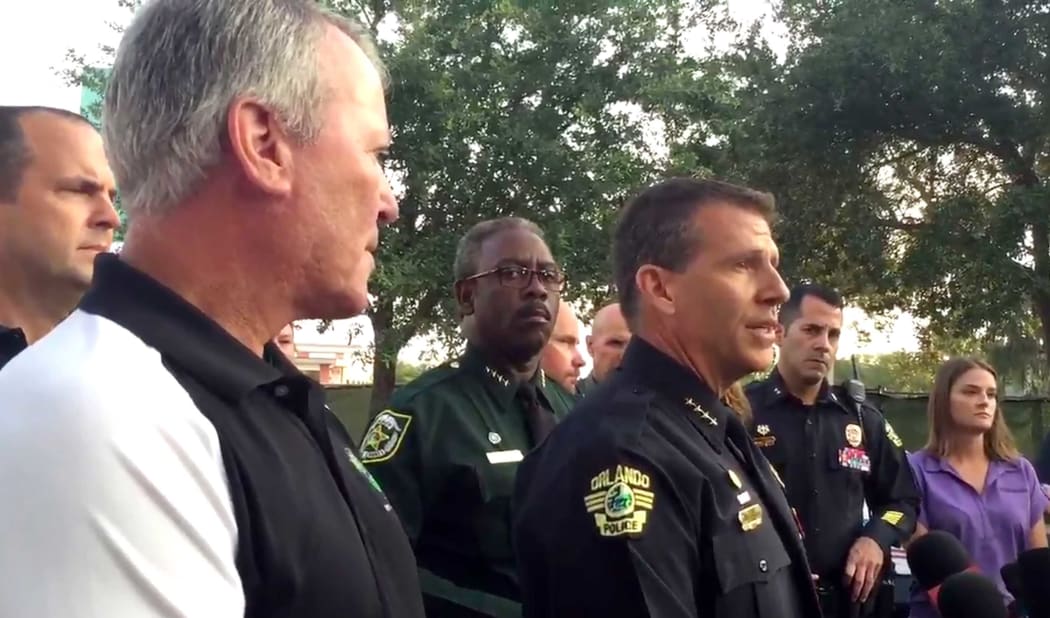 Florida police chief John Mina(R) speaking at a press conference following a mass shooting at the Pulse Night Club in Orlando as mayor Buddy Dyer looks on.
