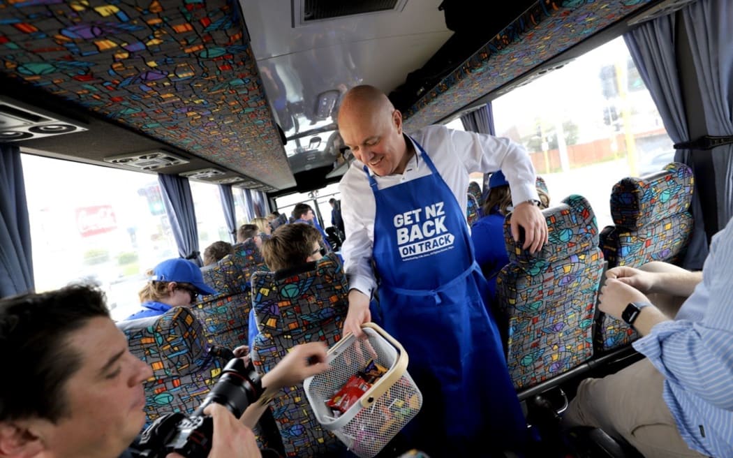 National leader Christopher Luxon handing out treats on the party's campaign bus.