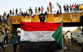 Sudanese demonstrators demand a civilian transition government in front of military headquarters this month.