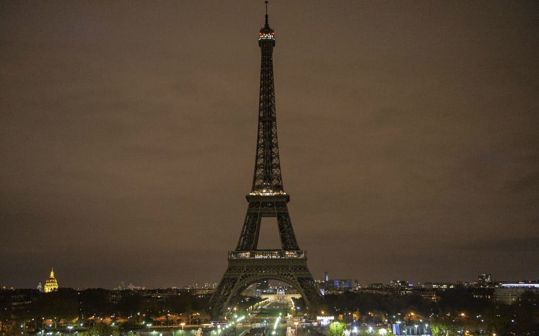 The Eiffel Tower without a night illumination to honor the memory of victims of the deadly terror attacks.