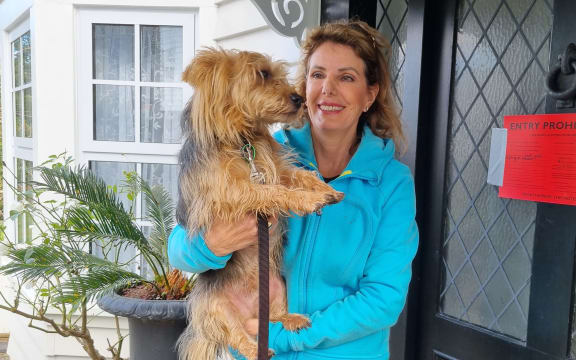Parnell resident Luci Harrison and dog Baxter haven't been able to live in their home since it was red-stickered after the Auckland Flooding event in January.