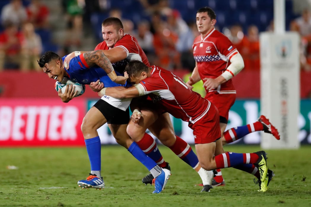 Tusi Pisi is tackled during Samoa's Rugby World Cup Pool A match against Russia in Kumagaya.