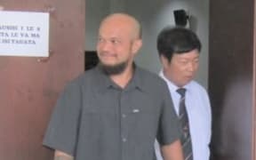 Chen Pao right with a relative leaving the courtroom