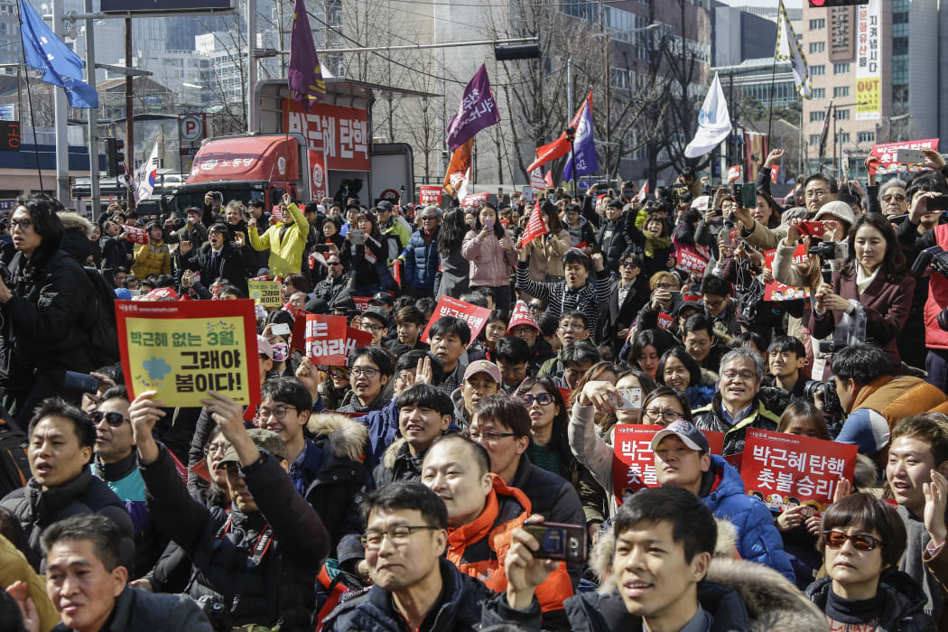 People react after hearing the Constitutional Court's verdict during a rally calling for impeachment of President Park Geun-hye near the Constitutional Court in Seoul, South Korea.