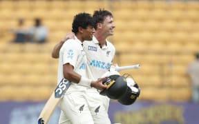 Rachin Ravindra (L) and Will Young leave the ground after New Zealand won the first test against India in Bengaluru.