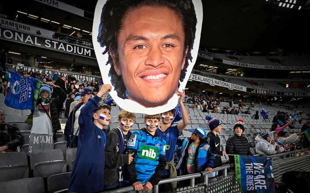 Blues fans hold up a cutout of Caleb Clarke.