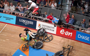 England's Matt Walls (number 29) and Canada's Derek Gee (15) go over the barrier into the crowd during the Men's 15km Scratch Race Qualifying Round at the Commonwealth Games on 31 July 2022