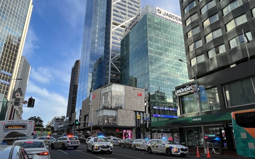 About 20 police cars at a cordon in Commercial Bay after gunshots were fired in Auckland's CBD, 20 July 2023.