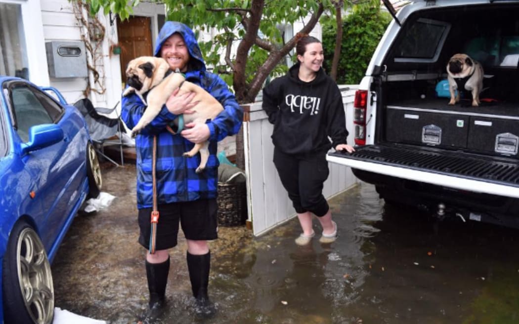 Shay Casey and Hannah Mutch, evacuating their Kirkcaldy Street home on Friday 4 October 2024, taking their pugs.