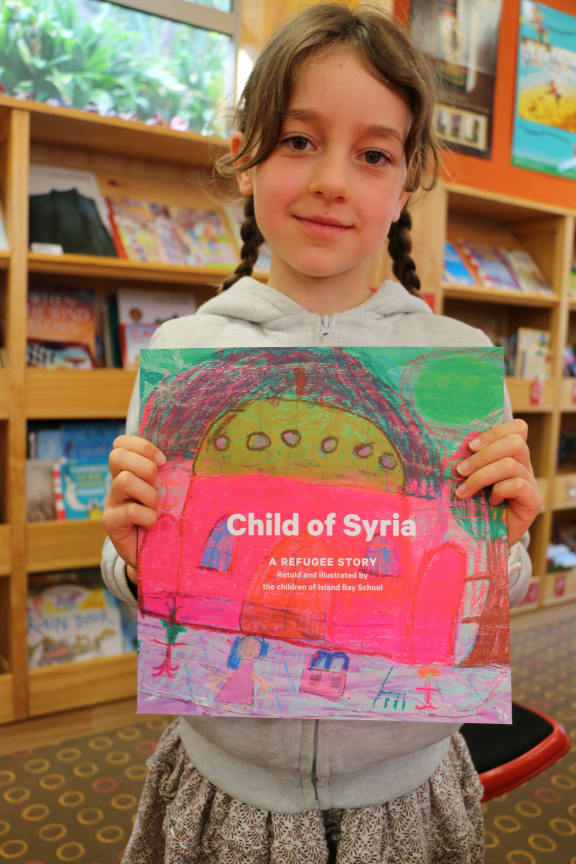 Hannah Stark holds Child of Syria book