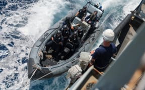 A boarding team comes alongside HMS Tamar
