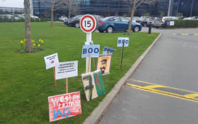 Protest signs outside IAG's Christchurch office.