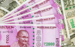 Close up view of brand new indian 2000 rupees banknotes. 500 rupee banknotes in background.