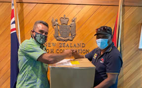 New Zealand's High Commissioner in Papua New Guinea, Phillip Taula, hands over media equipment to local state broadcaster NBC, 23 February 2021.