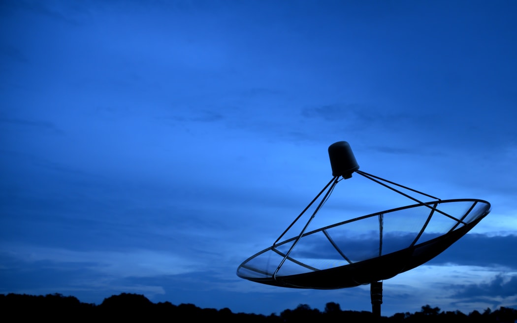 Big Black Satellite Dish on blue sky.