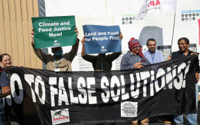 Climate activists from the Asian People's Movement on Debt and Development (APMDD) protest at the Sharm el-Sheikh International Convention Centre, in Egypt's Red Sea resort city of the same name, during the COP27 climate conference today.