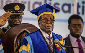 Zimbabwe's President Robert Mugabe delivers a speech during a graduation ceremony at the Zimbabwe Open University in Harare, where he presides as the Chancellor on November 17 2017.