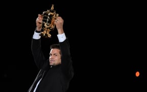 Former New Zealand international Richie McCaw holds the Rugby World Cup trophy during the tournament's opening ceremony at the Tokyo Stadium in Tokyo on September 20