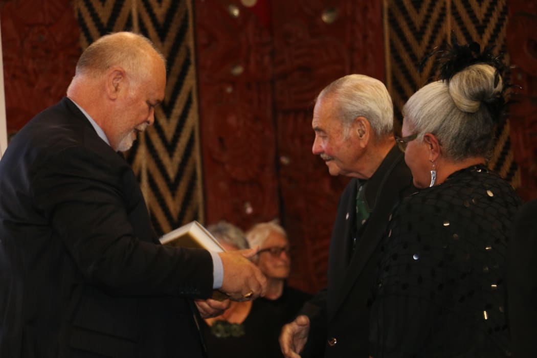 A copy of the book is handed to Robert Bom Gillies, the last surviving veteran of B Company of the 28th Māori Battalion