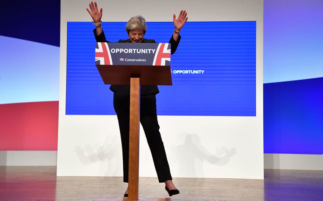 Britain's Prime Minister Theresa May waves as she gives her keynote address on the fourth and final day of the Conservative Party Conference 2018 at the International Convention Centre in Birmingham, central England, on October 3, 2018.