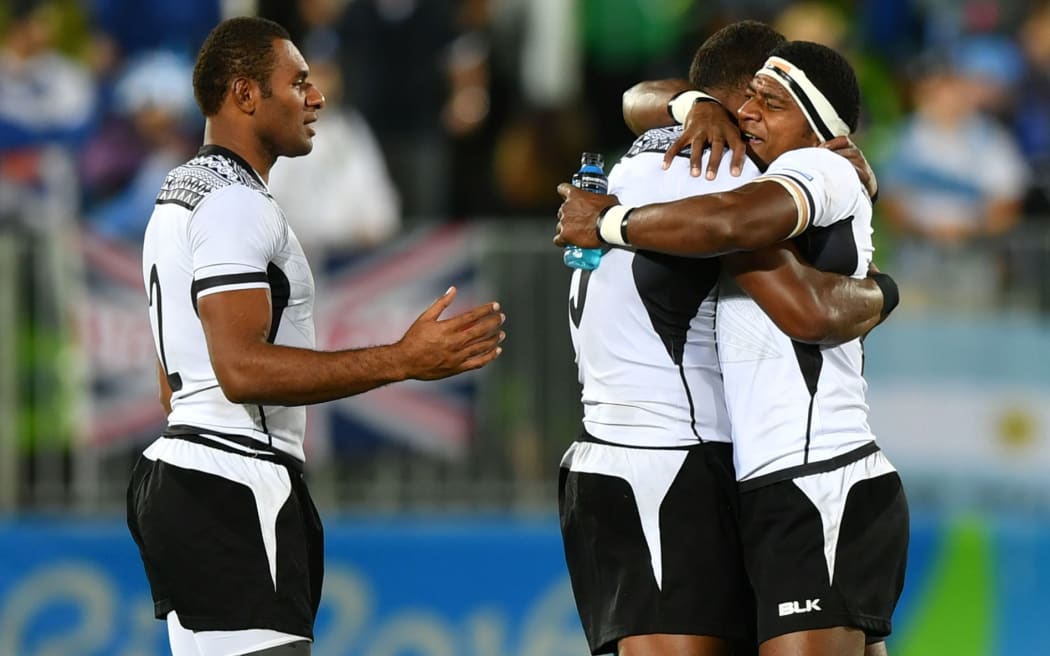 Fiji's players celebrate victory in the men’s rugby sevens gold medal match between Fiji and Britain during the Rio 2016 Olympic Games at Deodoro Stadium in Rio de Janeiro on August 11, 2016.