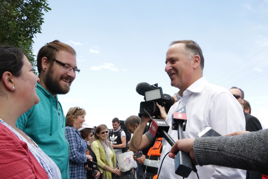John Key talks to tourists waiting to leave