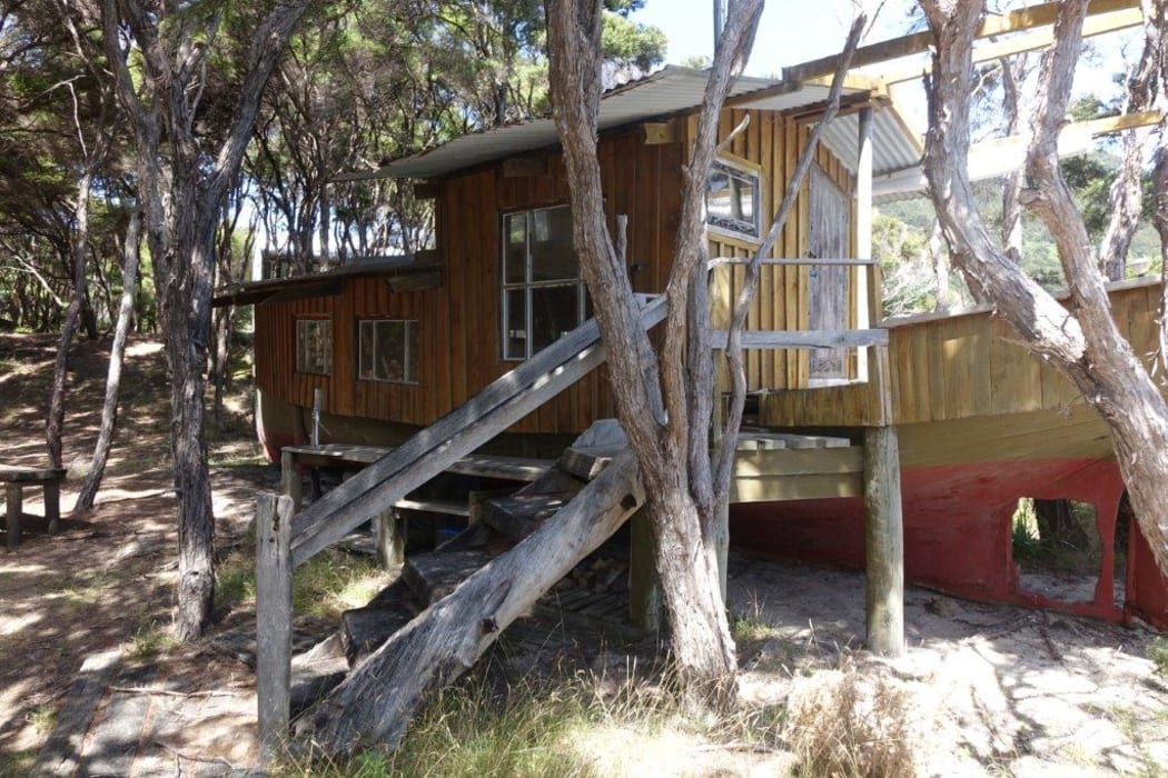 One of three dwellings on the beachfront property for sale at Awaroa is a re-fashioned boat. A crowd funding campaign has raised millions to purchase the land.15 February 2016.