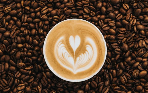 coffee cup in coffee beans