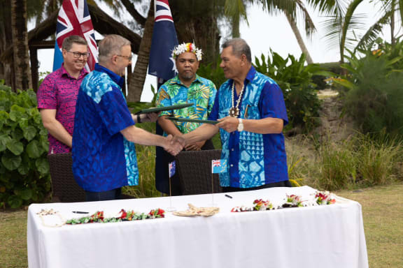 Australia and Tuvalu sign the Falepili Union treaty in Rarotonga: Australian PM Anthony Albanese, (front left) and Tuvalu PM Kausea Natano exchange the agreement. 10 November 2023