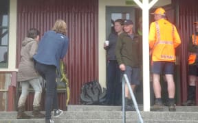 The missing woman, left, returns to the camphouse at North Egmont Visitors Centre.