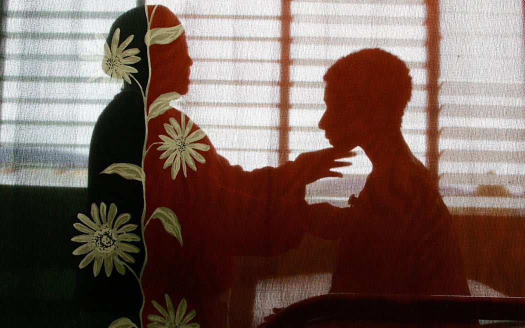 A woman at Mt Hagen Hospital is told by a nurse (left) in 2004 that she has HIV. A few years ago, PNG was lauded for its efforts to contain the virus, but infection rates are now rising.