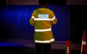 A police officer at a alcohol check point.