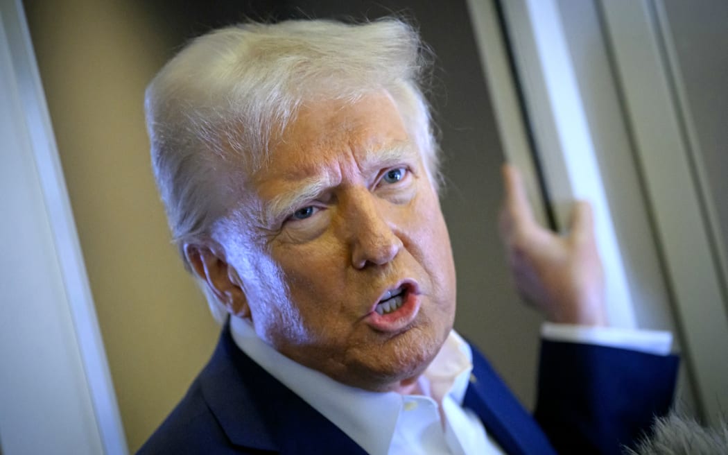 US President Donald Trump speaks with the press on board Air Force One after departing Las Vegas, Nevada, en route to Miami, Florida on January 25, 2025. After visits to disaster sites in North Carolina and California, the Vegas stop is more of a feel-good victory lap, as he lays out his plans to exclude tips from federal taxes -- an enormously popular move in a city built on the hospitality industry. (Photo by Mandel NGAN / AFP)
