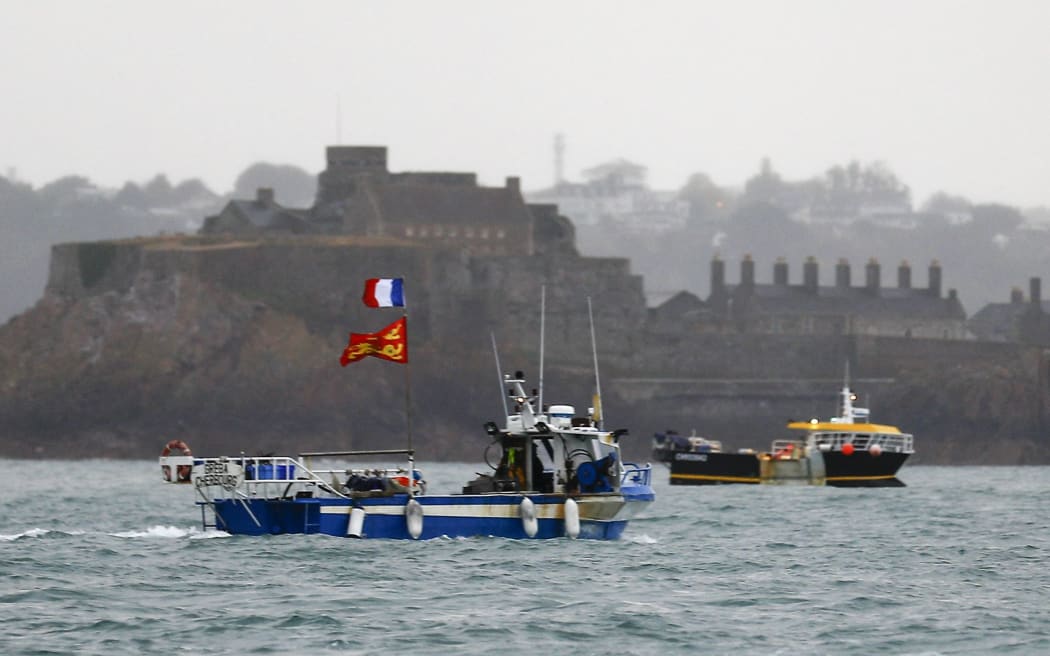 ALTERNATIVE CROP - French fishing boats protest in front of the port of Saint Helier off the British island of Jersey to draw attention to what they see as unfair restrictions on their ability to fish in UK waters after Brexit, on May 6, 2021.