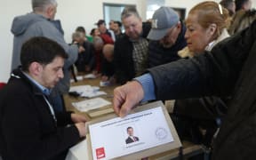 A man shows a ballot paper of the only candidate of the opposition Republican People's Party (CHP) Ekrem Imamoglu during the presidential primaries at a polling station in Ankara on March 23, 2025. The popular opposition Istanbul Mayor Ekrem Imamoglu, who is the biggest political rival of President Recep Tayyip Erdogan, was arrested on March 19, just days before he was to be named the main opposition CHP's candidate for the 2028 presidential race. The opposition Republican People's Party (CHP) has opened the vote to anyone, not just party members, in the hope of a massive show of support for the beleaguered mayor.