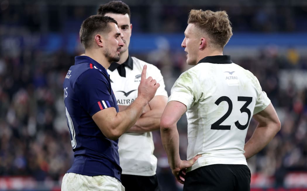 France's Thomas Ramos and New Zealand's Damian McKenzie talk after the match.