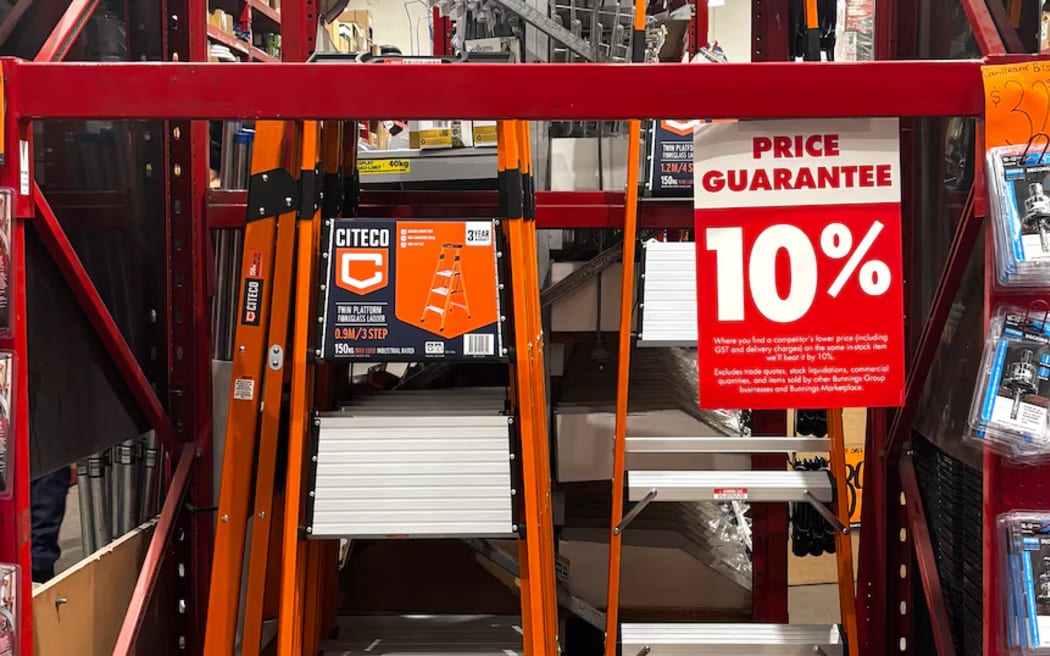A Citeco ladder with a sign that says" "Where you find a competitor's lower price on the same in-stock item we'll beat it by 10%."