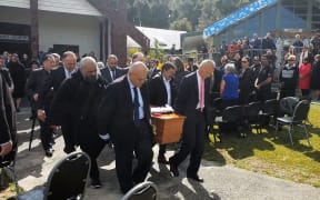 Pallbearers carry Pita Paraone's coffin for burial at his ancestral urupā.