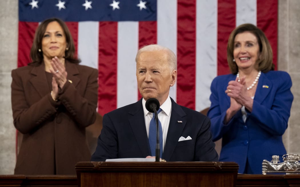 US Vice President Kamala Harris (L) and US House Speaker Nancy Pelosi (D-CA) applaud US President Joe Biden as he delivers his first State of the Union address at the US Capitol in Washington, DC.