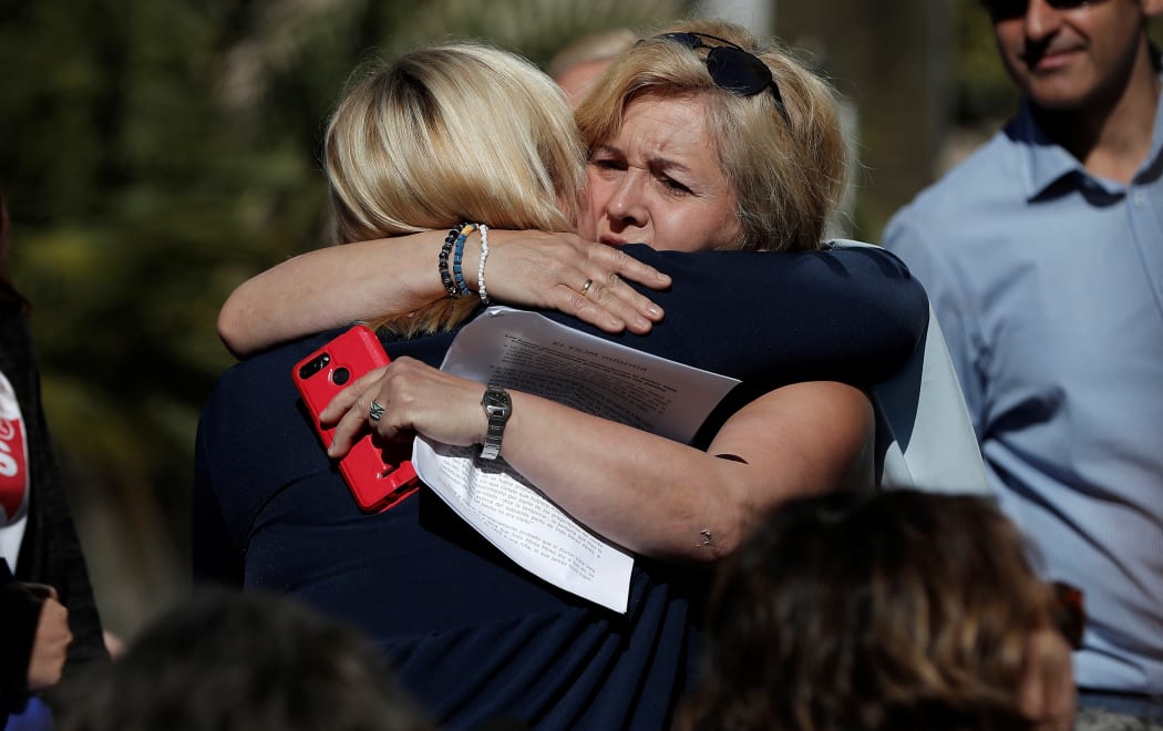 Ines Madrigal (left), 49, who was taken away from her mother as a newborn in 1969, is seen hugging someone after the baby trafficking trial.
