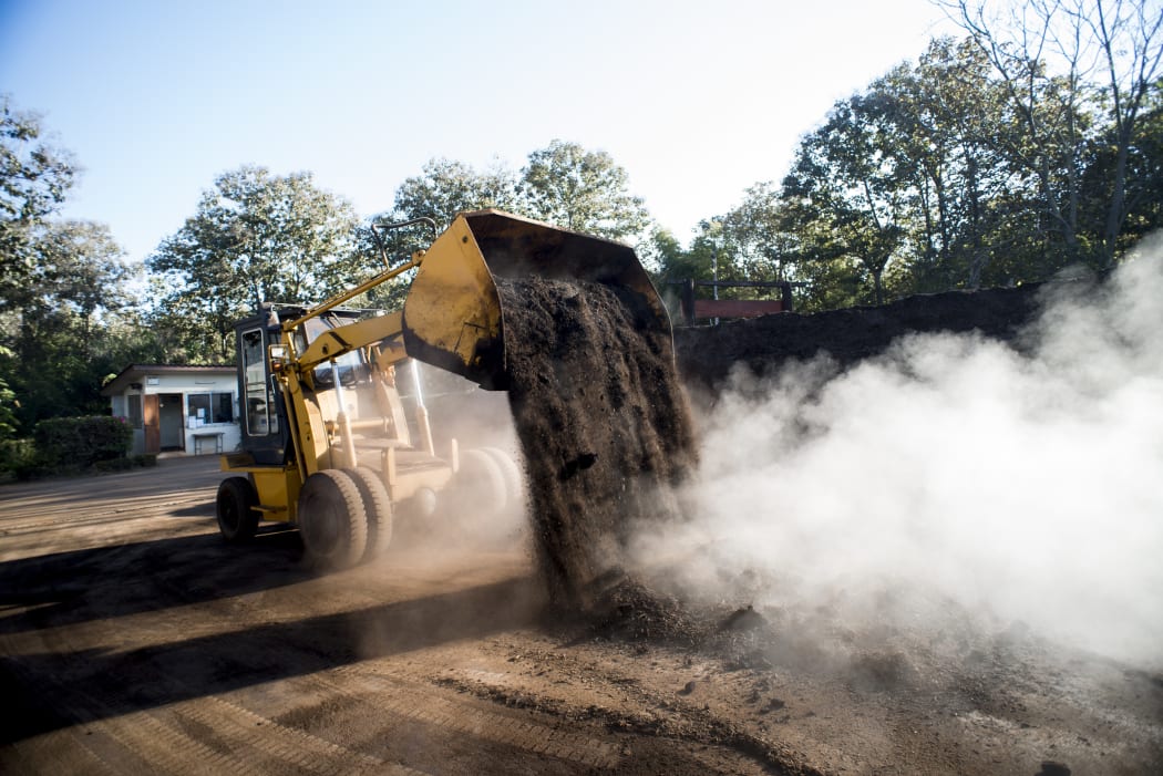 Front loader working with organic compost production