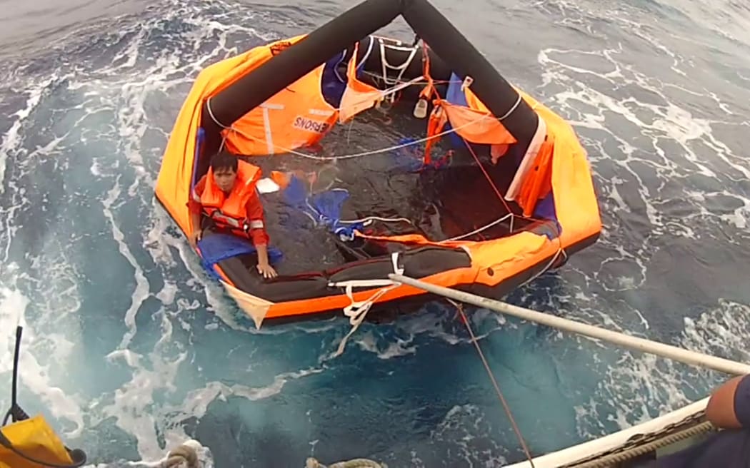 A man being rescued from a life raft by coast guards, about 2 kilometres north-northwest of Kodakarajima island of Kagoshima prefecture on September 4, 2020 after the sinking of Gulf Livestock 1.