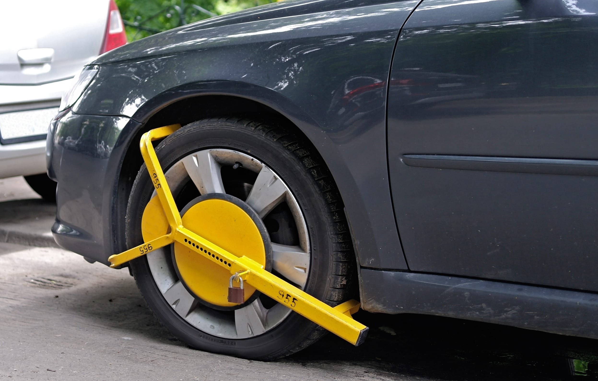 Wheel clamp mounted on parked car