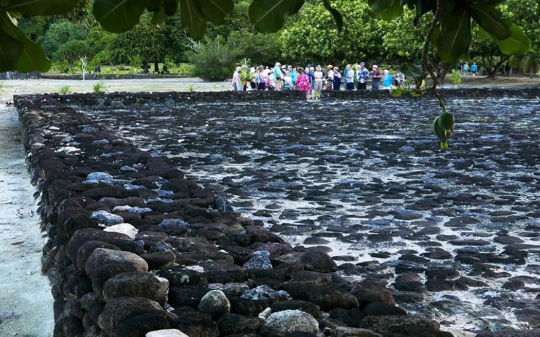 Tour group visits marae at Taputapuatea, on Ra'iatea in French Polynesia.