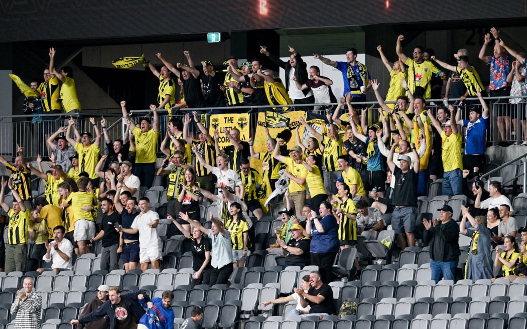 Wellington Phoenix fans celebrate a goal during the A-League match against Perth Glory in Sydney.