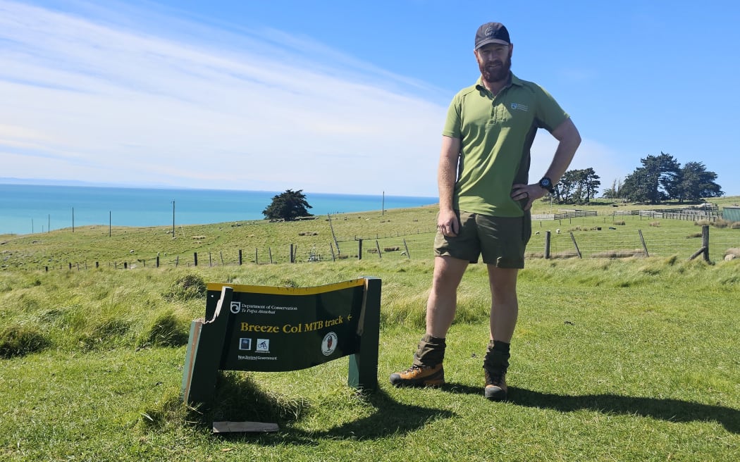 DOC Asset Inspector Charlie Barnett with a damaged sign