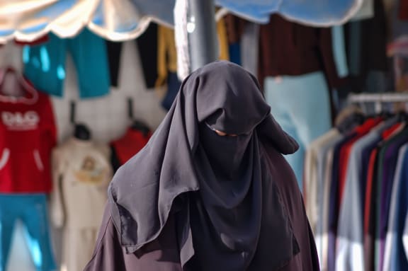 21293717 - woman in a burqa on the streets of egypt